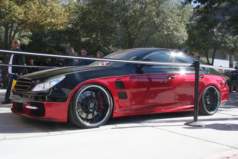 Custom two-tone black and red coupe with aftermarket wheels and body kit