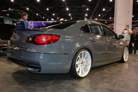 1998 Ford Crown Victoria - A gray Volkswagen CC is displayed with custom white wheels, viewed from the rear three-quarter angle.