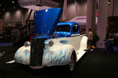 1998 Ford Crown Victoria - A custom pickup truck with a two-tone paint job and flame graphics is displayed with its hood open.