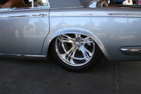 1998 Ford Crown Victoria - Side profile of a silver sedan custom chrome wheels and a lowered stance.