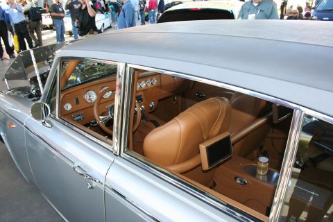 1998 Ford Crown Victoria - Custom interior features tan leather seats, racing gauges, and a roll cage visible through the window.