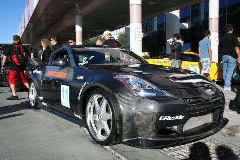 1998 Ford Crown Victoria - Modified Nissan 350Z with carbon fiber body kit and racing decals parked at an event.