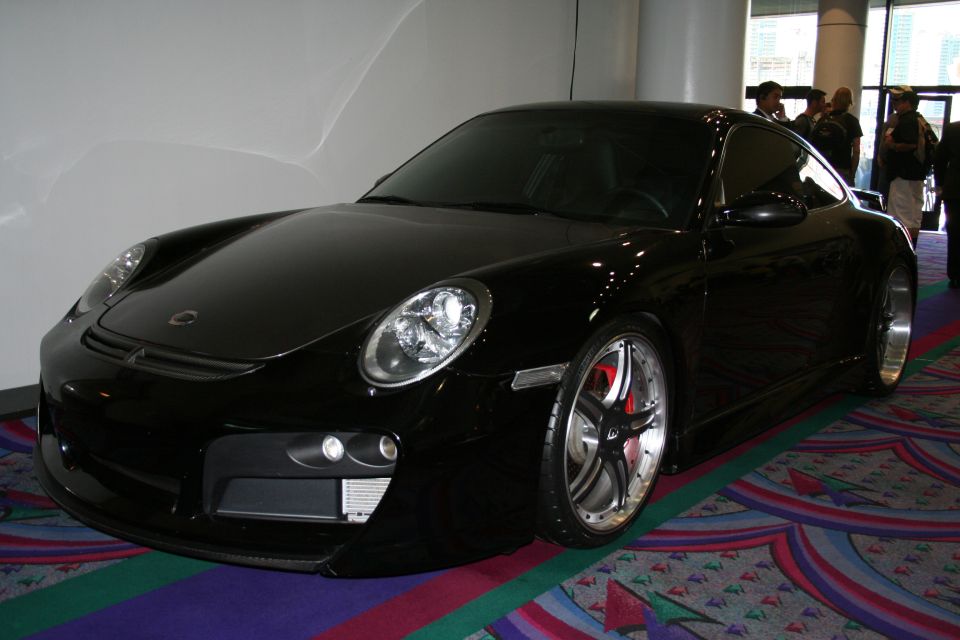 Black Porsche 911 with custom wheels and red brake calipers