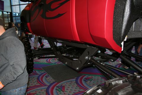 1998 Ford Crown Victoria - Custom lifted truck with red body and tribal graphics, shown from the side with focus on suspension.