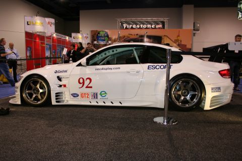 1998 Ford Crown Victoria - A white race car with prominent number 92 and various sponsor decals is displayed indoors.