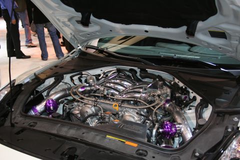 1998 Ford Crown Victoria - Customized engine bay twin turbochargers and vibrant purple blow-off valves, suggesting performance modifications.