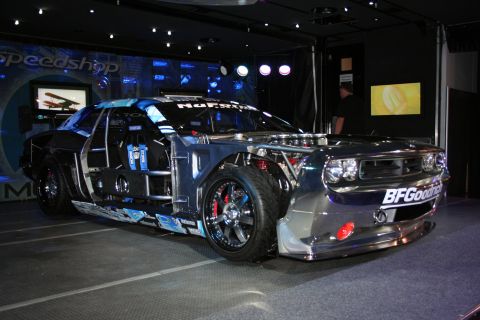 1998 Ford Crown Victoria - This heavily modified vehicle features a chrome finish, exposed engine components, and a prominent roll cage, suggesting a racing purpose.