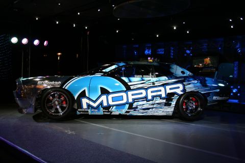 1998 Ford Crown Victoria - This Mopar branded race car features striking blue and white graphics along its side, presented in a three-quarter front view.
