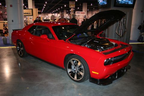1998 Ford Crown Victoria - A red Dodge Challenger is displayed with its hood open, revealing the engine and custom modifications.