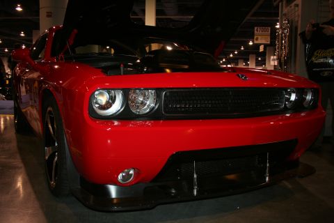 1998 Ford Crown Victoria - Red Dodge Challenger with hood open at a car show.
