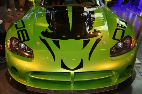1998 Ford Crown Victoria - Lime green Dodge Viper with a prominent black snake graphic on the hood and racing stripes.