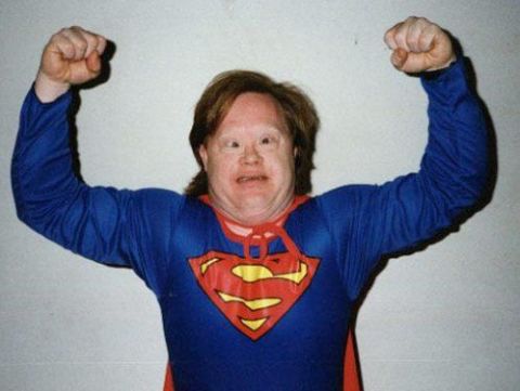 1987 Ford Bronco - Person in a Superman costume poses with flexed arms.