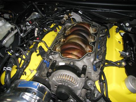 2003 Mercury Marauder - Close-up view of an engine bay, highlighting yellow valve covers and an open intake manifold.