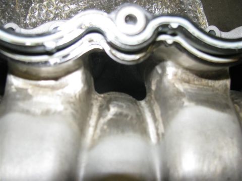 2003 Mercury Marauder - Close-up of an engine intake manifold, revealing internal porting and a gasket seal.