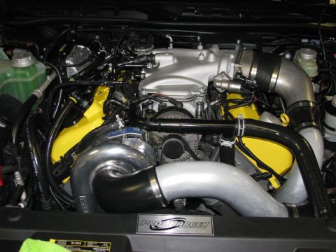 2003 Mercury Marauder - Engine bay features a ProCharger supercharger system and custom yellow engine components.
