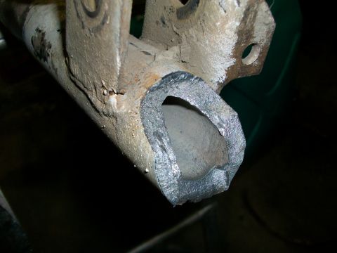 1992 Ford F-350 - A close-up view of a damaged metal component, likely from a vehicle's undercarriage.