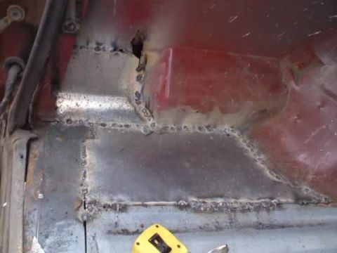 1988 Ford Bronco - Close-up view of a metal panel showing extensive welding repairs.
