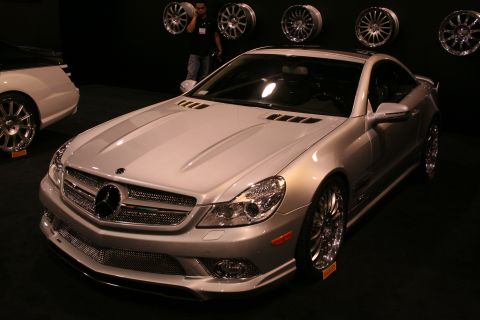 1998 Ford Crown Victoria - Silver Mercedes-Benz SL-Class coupe on display with custom wheels and another vehicle nearby.