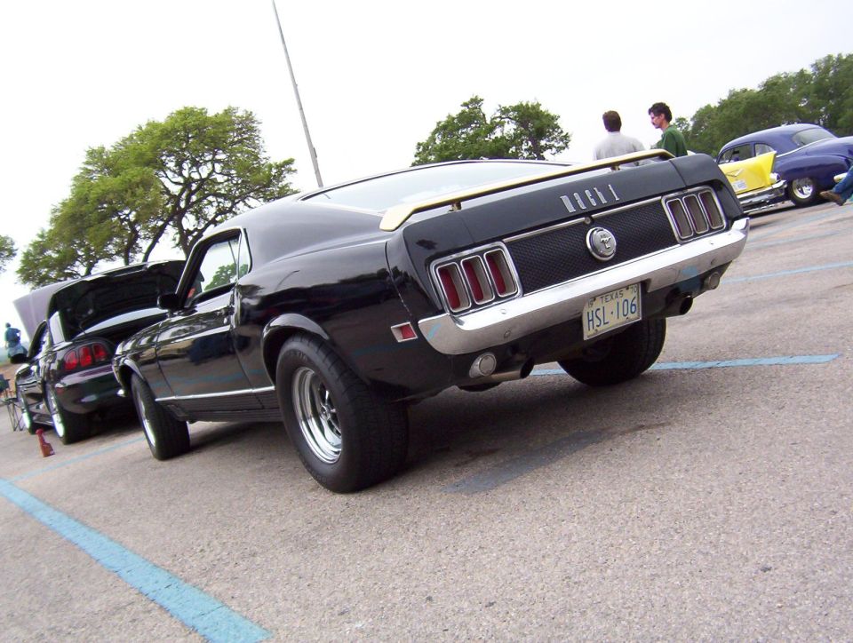 Black 1969 Ford Mustang rear quarter view, showing taillights and license plate HSL-106