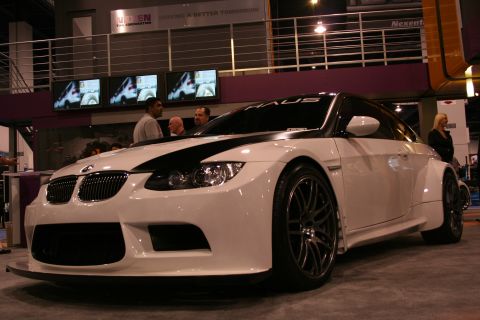 1998 Ford Crown Victoria - Modified white BMW M3 coupe with widebody kit and racing stripes on display.