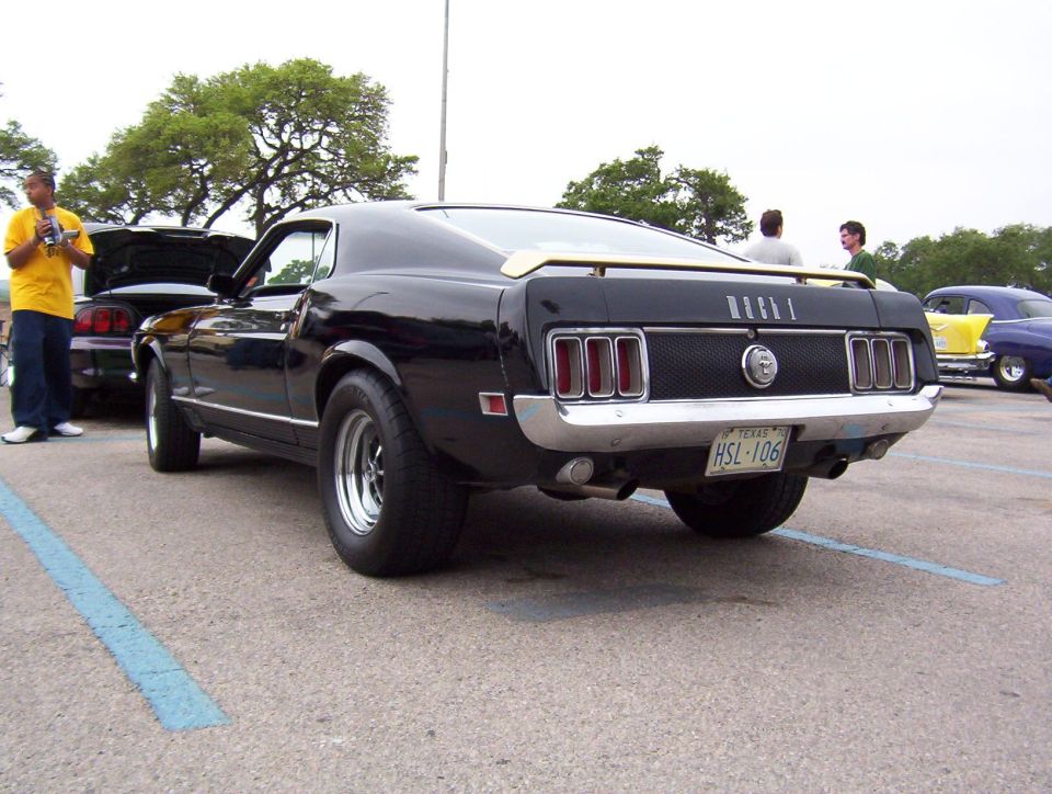 Black 1970 Ford Mustang parked, showing rear end and license plate HSL-106