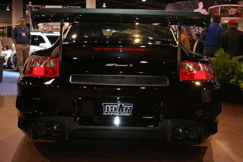 1998 Ford Crown Victoria - Rear view of a modified Porsche 911 GT2 with a prominent spoiler and custom exhaust.