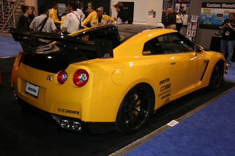 1998 Ford Crown Victoria - A yellow Nissan GT-R is displayed with custom aftermarket parts.