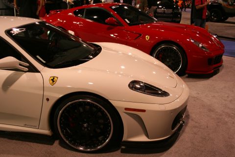 White and red sports cars parked side-by-side