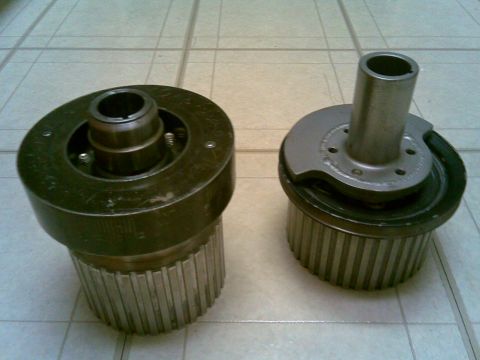 1972 Ford Ranchero - Two automotive pulleys are shown on a tiled floor.