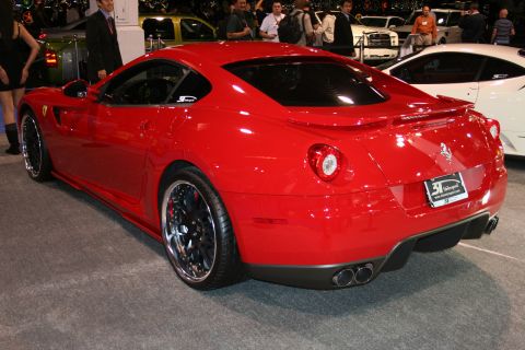 Red Ferrari coupe, rear 3/4 view, custom wheels, aftermarket exhaust, license plate frame