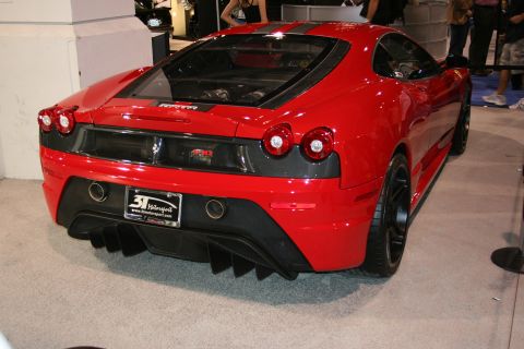 Red Ferrari F430 Scuderia rear view with quad exhaust and diffuser. License plate reads 31 Motorsports