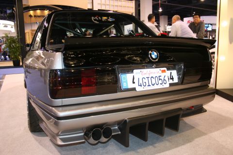 Rear view of a modified BMW M3 E30 with custom diffuser and dual exhaust