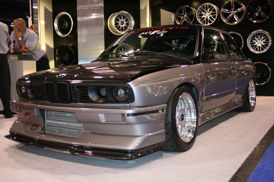 Modified BMW E30 M3 with custom front bumper and carbon fiber hood