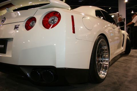 White Nissan GT-R rear view with dual exhaust and large spoiler