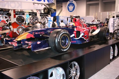 Formula 1 race car with Red Bull livery on display stand, tires labeled POTENZA BRIDGESTONE