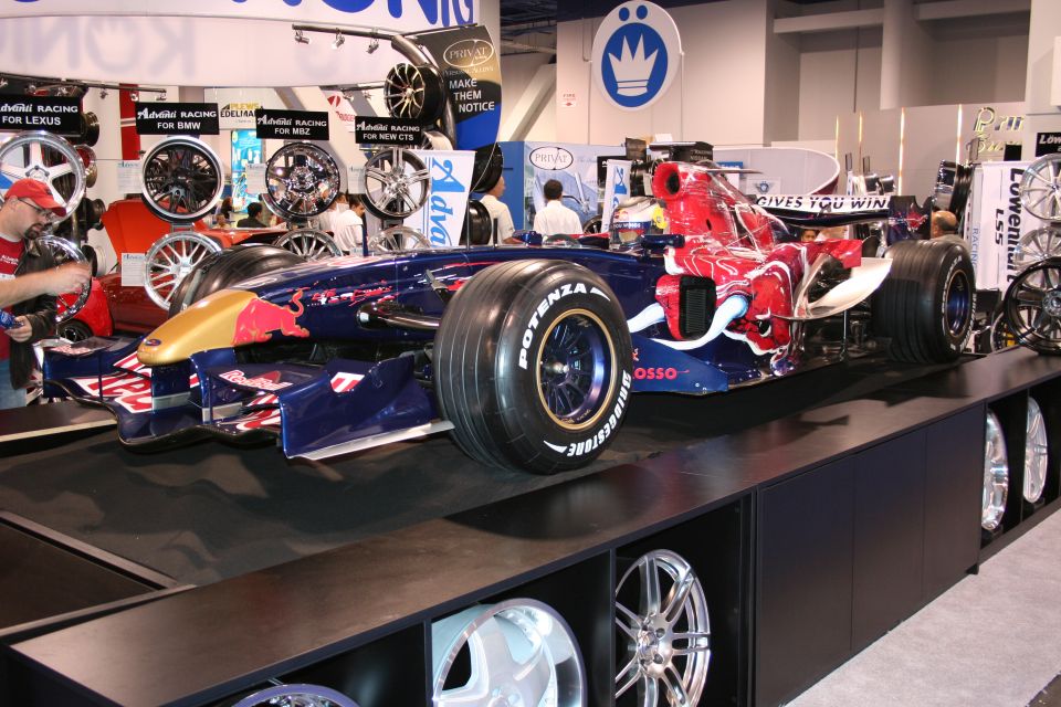 Formula 1 race car with Red Bull livery on display stand, tires labeled POTENZA BRIDGESTONE