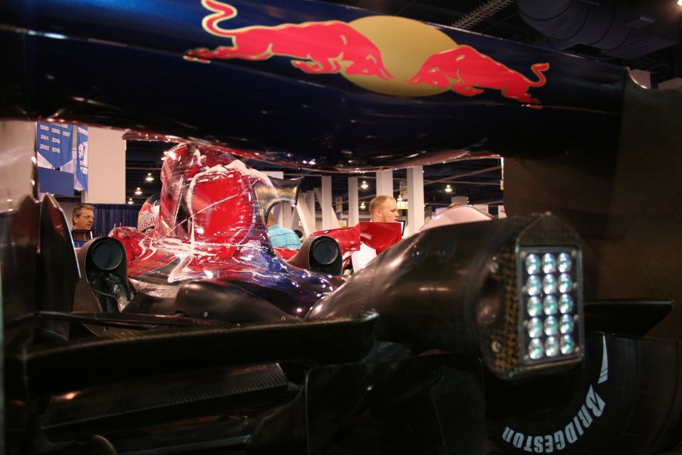 Red Bull F1 car front view with Red Bull logos on the wing. Bridgestone tire visible
