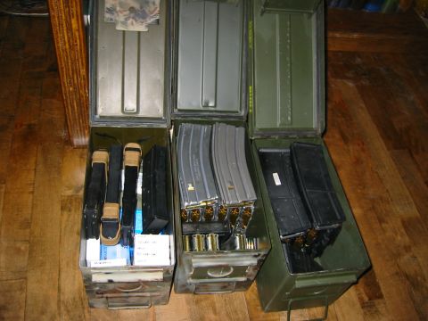 1996 Ford Bronco - Several ammo cans are open, revealing rows of loaded magazines and loose cartridges.