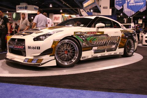 White and gold sports car with racing decals, "Bulletproof" branding, and custom wheels