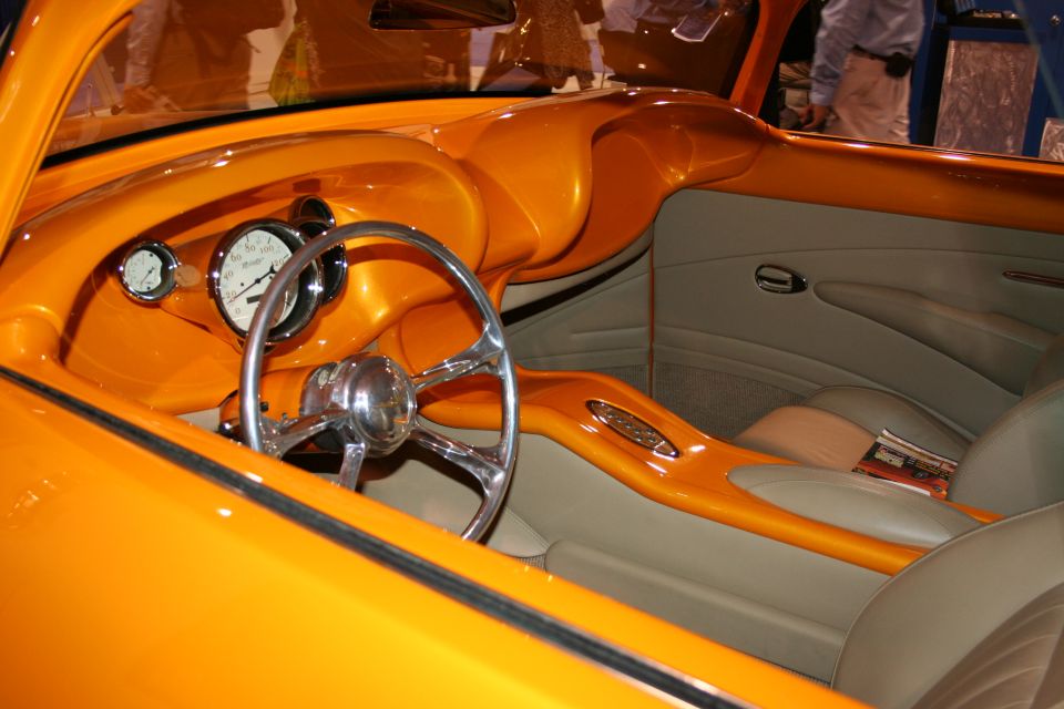 Custom orange and tan interior with chrome steering wheel and gauges