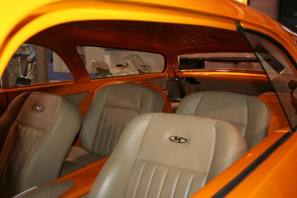 Tan leather bucket seats inside a custom orange show car