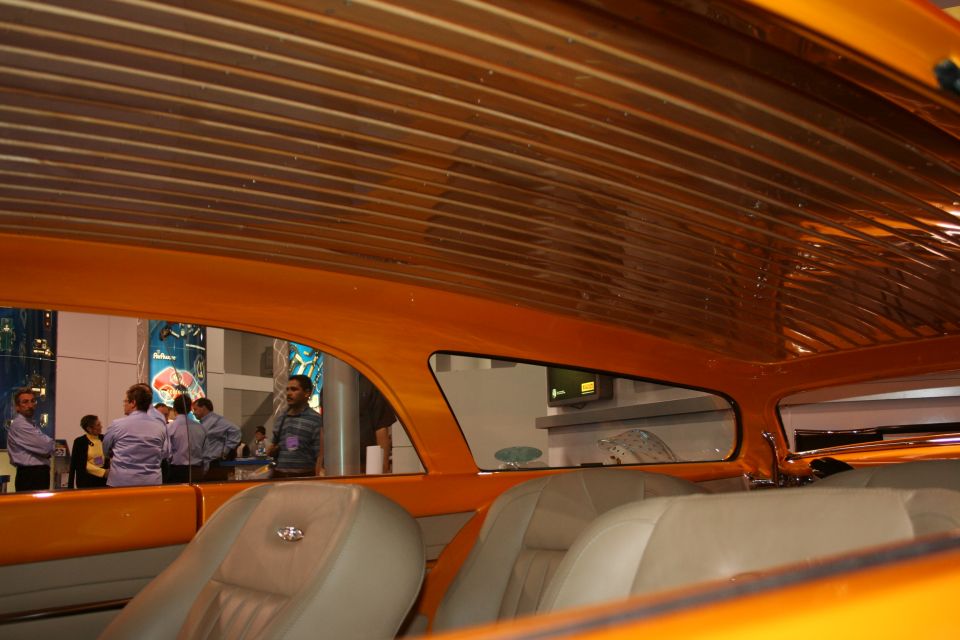 Wood-slat headliner and tan seats inside a custom orange show car