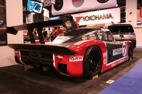 Rear of a red and black number 7 BMW prototype race car at a show