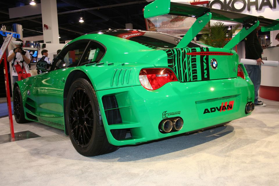 Rear three-quarter of a green widebody BMW Z4 race car with big wing