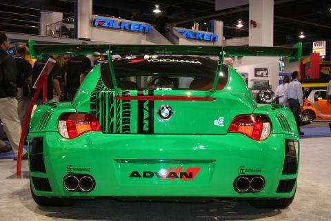 Rear view of a green widebody BMW Z4 race car with twin exhausts