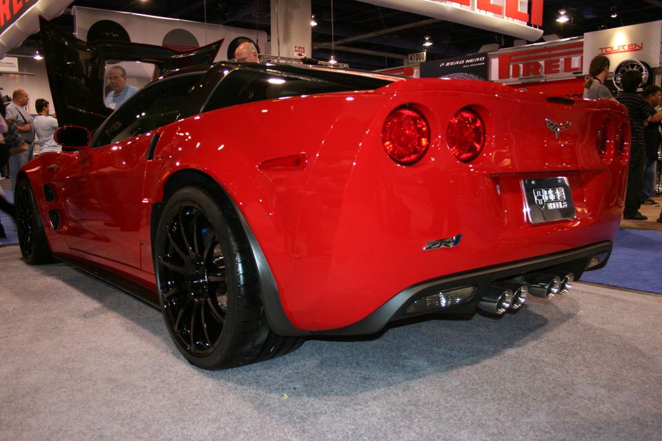 Red Chevrolet Corvette ZR1 rear view with black wheels at an auto show