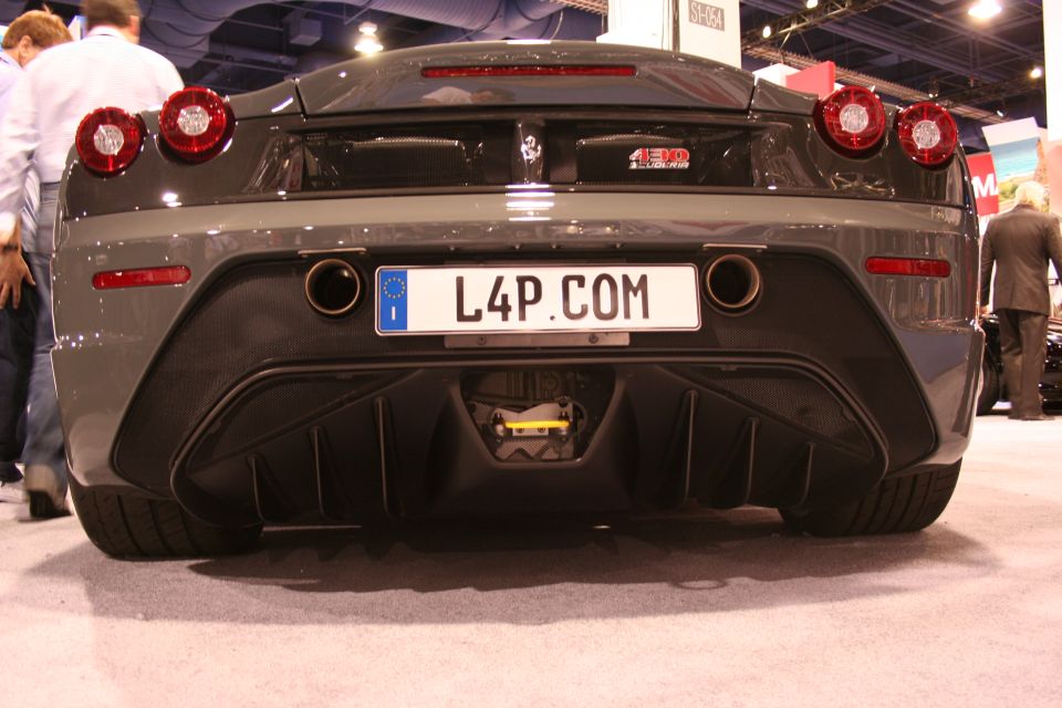 Grey Ferrari 430 Scuderia rear view with L4P.COM plate at an auto show