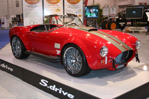 Red Shelby Cobra replica roadster on an S.drive display platform
