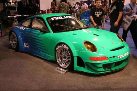 Green and blue Falken Porsche 911 GT3 race car front three-quarter view