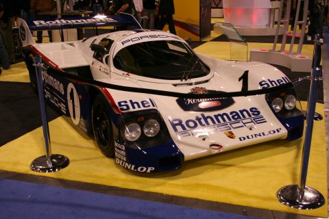 Rothmans Porsche 962 Le Mans race car on a display stand